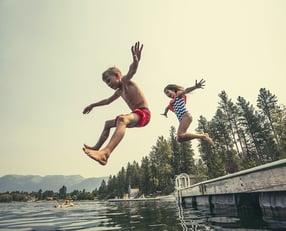 bigstock-Kids-jumping-off-the-dock-into-117925061.jpg