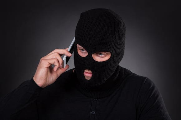 bigstock-Thief-Using-A-Stolen-Mobile-Ph-66703411.jpg